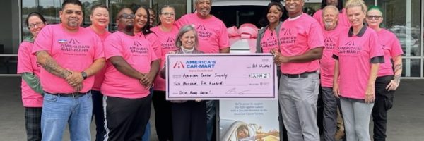 Car-Mart associates posing for picture in Woodstock, Georgia holding big Check for Donation to the American Cancer Society 2023