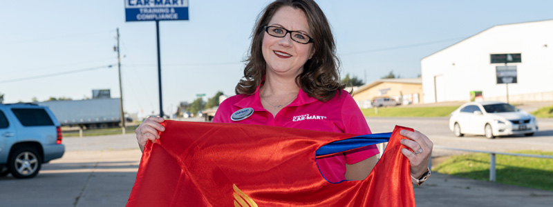 Kristina Carpenter holding her Wonder Woman cape.