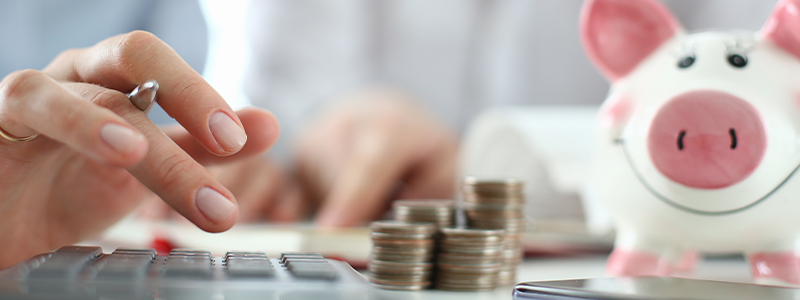 Save money. Woman with calculator, coin money and a piggy bank