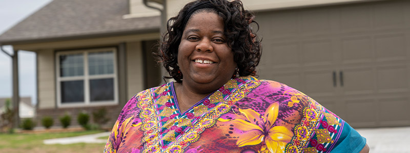 Nicole Tomlin in front of her new home