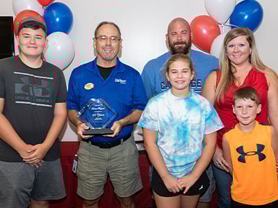 Bruce Bryant with his family at his 25 years of service at Car-Mart party