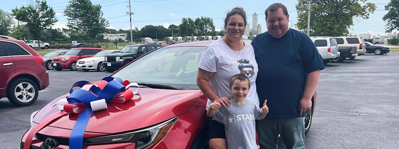 Nicole Harris and family standing by their new Toyota Corolla