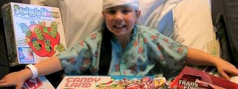 Eddie in his hospital bed surrounded by toys