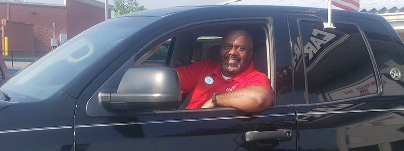 Mark Carlock, General Managers of Pine Bluff, Arkansas, sitting a a car