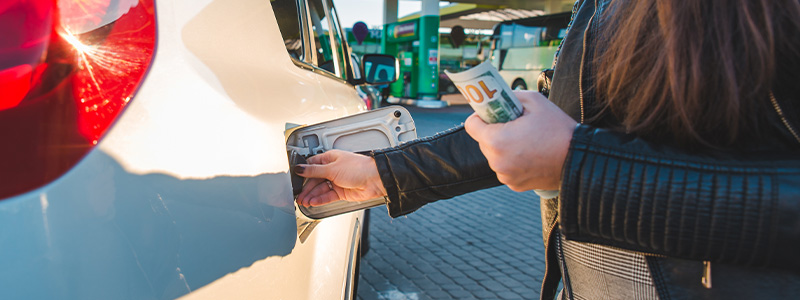 woman at gas station fuel up car