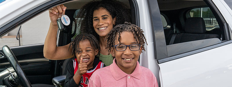 Mother with children in her new car from Car-Mart